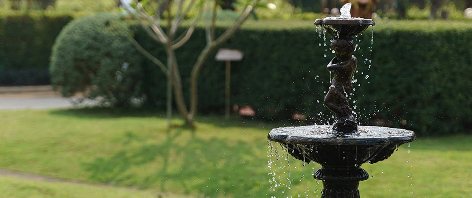 A black flowing water fountain installed in a backyard in Papillion, NE. 