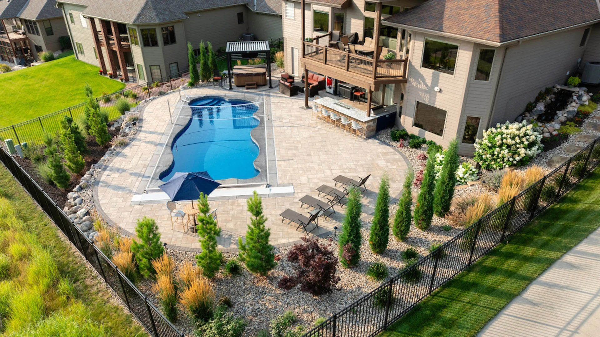 Full Outdoor Living Project in Omaha Featuring Pool Decking, Outdoor Kitchen & More