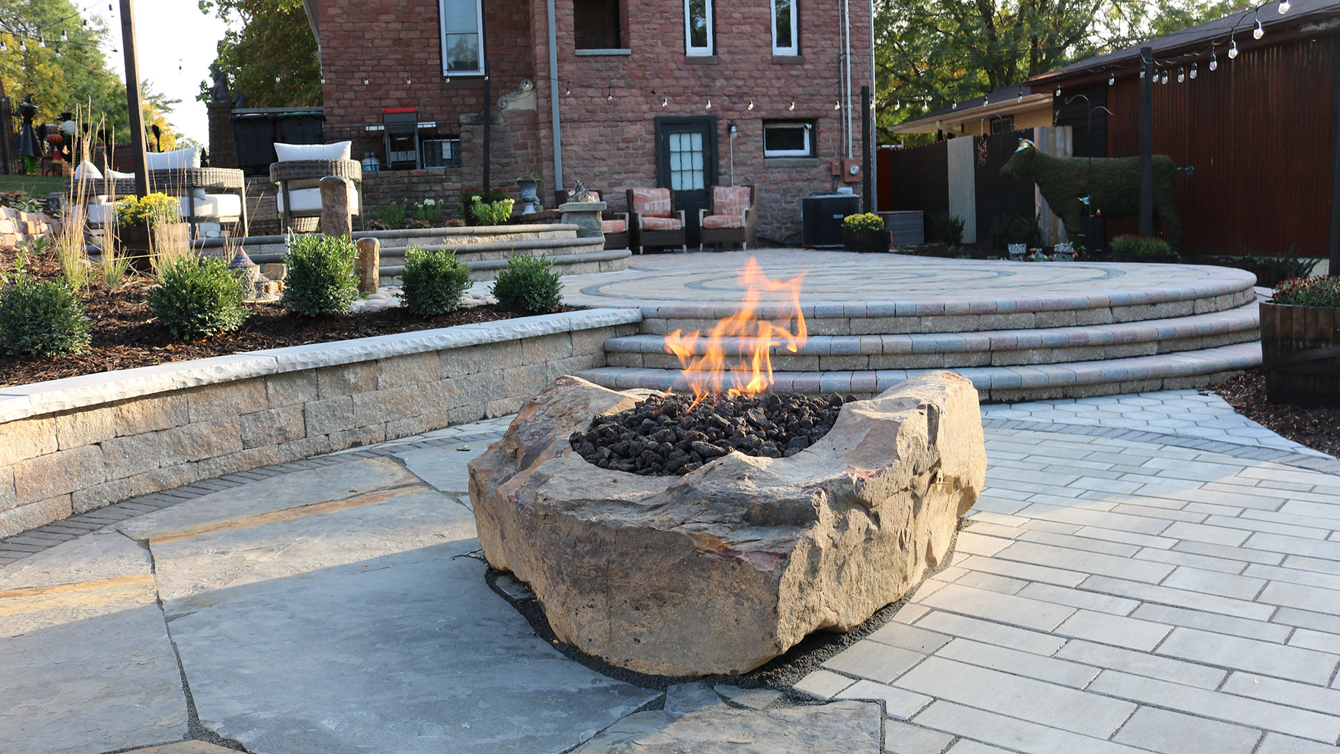 Custom fire pit installed over a custom patio in Chalco, NE.