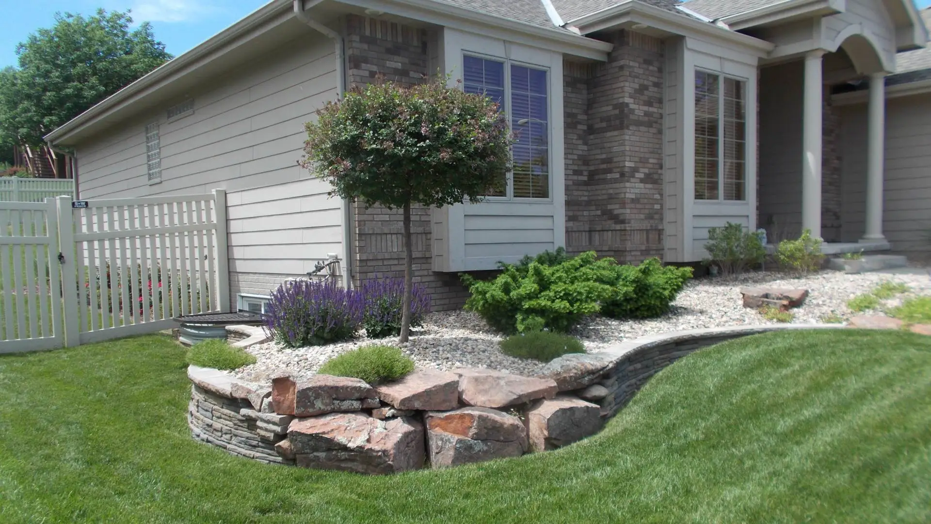 Landscape bed with rock ground covering in Waterloo, NE.