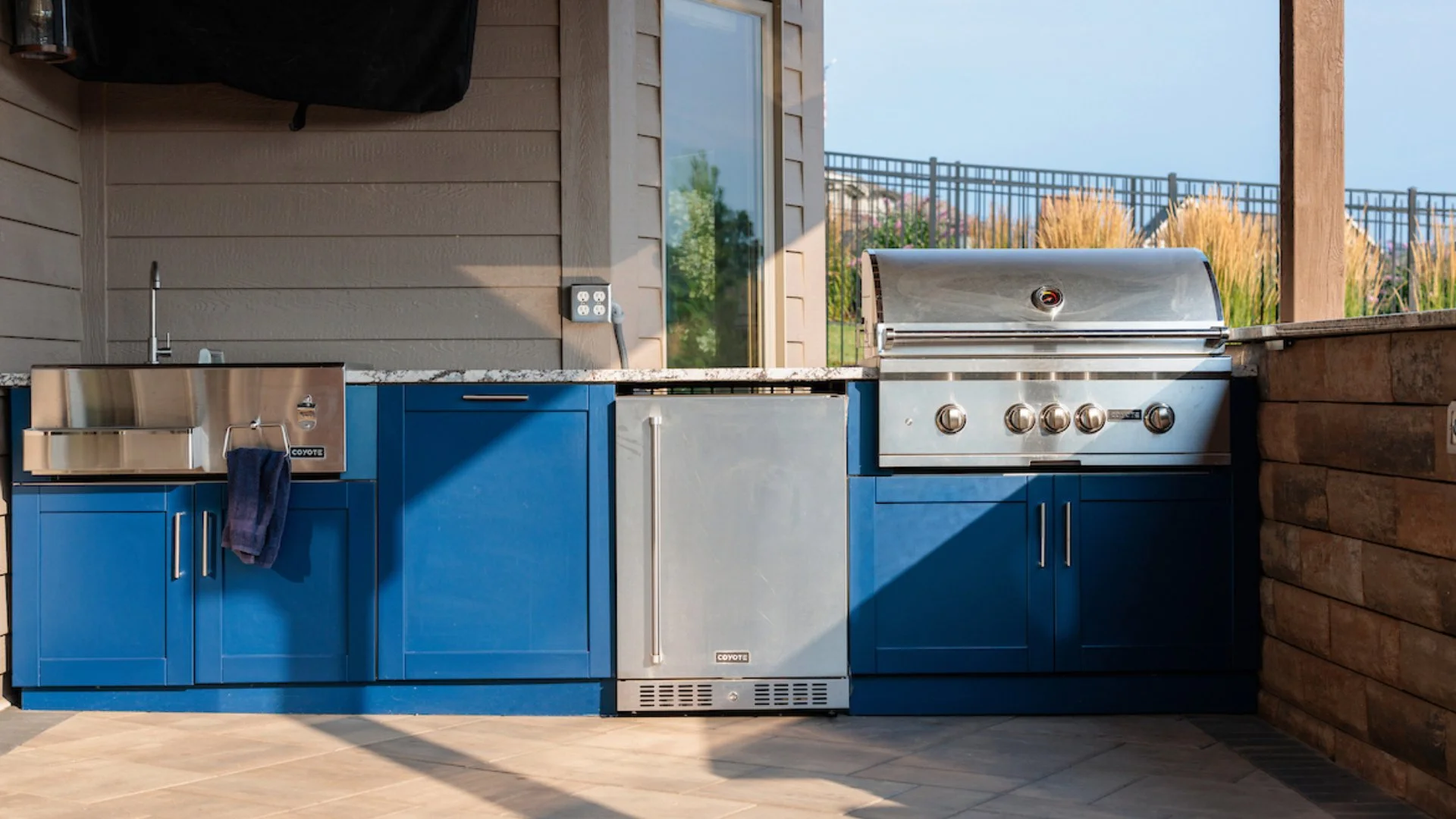 Modern outdoor kitchen area with grill and sink in Bennington, NE.