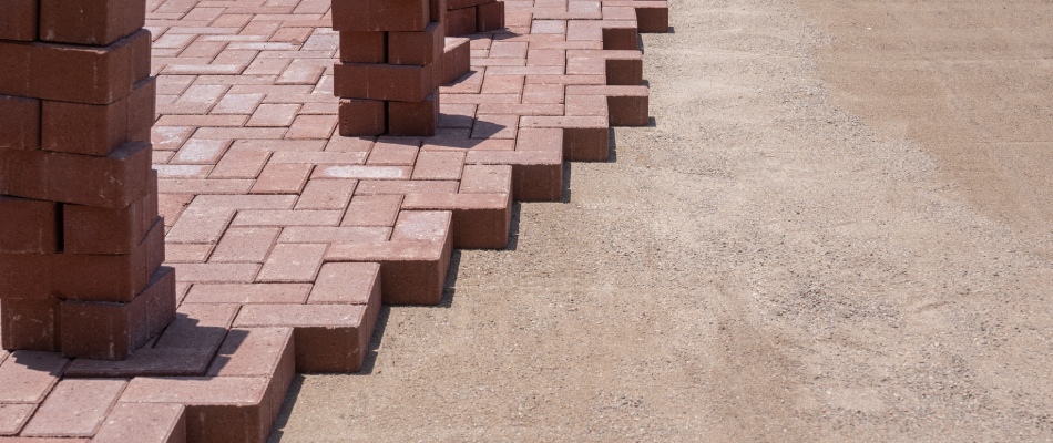 Stacks of red bricks ready to be installed into a custom driveway in Gretna, NE. 
