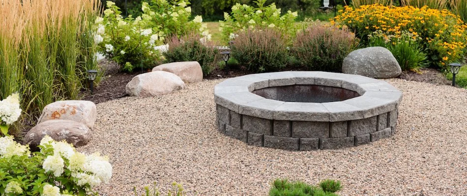 Fire pit and pea gravel on a property in Gretna, NE.