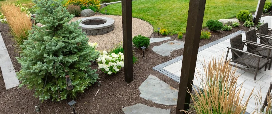 Patio area, fire pit, and landscaping on a property in Gretna, NE.