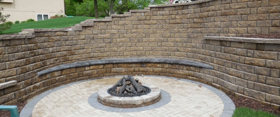 Seating wall built around fire pit it Waterloo, NE.