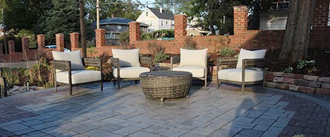 Custom patio with wicker chairs and ottoman in Waterloo, NE.
