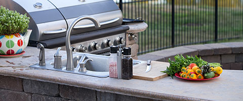 Custom outdoor kitchen with grill and sink near La Vista, NE.