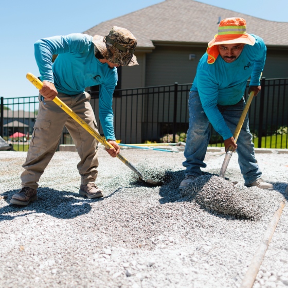 Workers from UPL shoveling gravel for project in Omaha, NE.